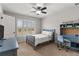 Cozy bedroom featuring a twin bed, a study desk with chair, and a window for natural light at 260 Millstone Pkwy, Woodstock, GA 30188