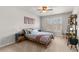 Well-lit bedroom with queen bed, a desk and chair, and large window providing natural light at 260 Millstone Pkwy, Woodstock, GA 30188