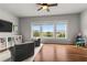 This bonus room boasts lots of natural light, hardwood floors, and a ceiling fan at 260 Millstone Pkwy, Woodstock, GA 30188