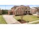 Expansive brick home with a long driveway, showcasing a well-maintained lawn and attached three-car garage at 260 Millstone Pkwy, Woodstock, GA 30188