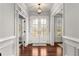 Bright foyer with double glass doors and hardwood floors, providing an elegant and welcoming entrance at 260 Millstone Pkwy, Woodstock, GA 30188