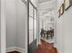 Hallway with a sliding barn door leading to a dining area, showcasing hardwood floors and elegant decor at 260 Millstone Pkwy, Woodstock, GA 30188