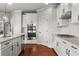 Well-equipped kitchen with stainless steel appliances, granite countertops, white cabinets, and hardwood floors at 260 Millstone Pkwy, Woodstock, GA 30188