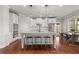 Modern kitchen featuring white cabinets, a large island with seating, stainless steel appliances, and hardwood floors at 260 Millstone Pkwy, Woodstock, GA 30188