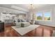 Open-concept living area with hardwood floors, large windows, and a view into the modern kitchen, creating a seamless flow at 260 Millstone Pkwy, Woodstock, GA 30188