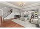 Spacious living room with hardwood floors, staircase, and open access to the kitchen, perfect for entertaining at 260 Millstone Pkwy, Woodstock, GA 30188