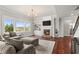 Bright living room features a fireplace, hardwood floors, and large windows offering natural light at 260 Millstone Pkwy, Woodstock, GA 30188