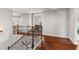 Staircase with hardwood floors and wrought iron railings, providing access to the upper level at 260 Millstone Pkwy, Woodstock, GA 30188