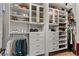 This walk-in closet is equipped with custom shelving, drawers, and hanging storage at 260 Millstone Pkwy, Woodstock, GA 30188