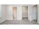 Spacious bedroom showcasing open doors to the bathroom and a closet, and plush carpeting at 2960 Fields Dr, Lithonia, GA 30038