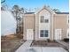 Attractive townhome featuring a symmetrical façade, arched window, and well-maintained landscaping at 2960 Fields Dr, Lithonia, GA 30038