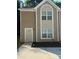 Inviting townhome featuring a neutral stucco facade, complemented by crisp white trim and a well-manicured landscape at 2960 Fields Dr, Lithonia, GA 30038