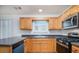 A bright kitchen with stainless steel appliances, and light wood cabinets at 2960 Fields Dr, Lithonia, GA 30038