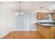 Inviting kitchen with wood cabinets, granite countertops, and a view of the adjacent dining area at 2960 Fields Dr, Lithonia, GA 30038