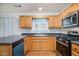 A well-equipped kitchen featuring stainless steel appliances, granite counters, and ample wood cabinets at 2960 Fields Dr, Lithonia, GA 30038