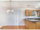 An eat-in kitchen features wood floors, paneled cabinets, and a modern lighting fixture at 2960 Fields Dr, Lithonia, GA 30038