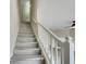 A pristine staircase with white banisters ascends to the upper level of the home at 2960 Fields Dr, Lithonia, GA 30038