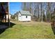 A backyard featuring a storage shed on a grassy lot, perfect for outdoor projects at 3220 Warren Creek Dr, Powder Springs, GA 30127