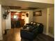 Spacious basement with wood floors, black leather seating, and a bar area at 3220 Warren Creek Dr, Powder Springs, GA 30127