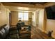 Spacious basement with wood floors, seating, a window, and television at 3220 Warren Creek Dr, Powder Springs, GA 30127