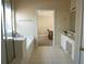 Bathroom features a separate tub and shower with tiled floor at 3220 Warren Creek Dr, Powder Springs, GA 30127