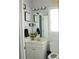 Bright bathroom with a vanity, mirror, and decorative lighting at 3220 Warren Creek Dr, Powder Springs, GA 30127