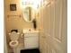 Bathroom featuring a sink, toilet, and ample natural lighting, all adorned with tasteful decorations at 3220 Warren Creek Dr, Powder Springs, GA 30127