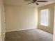 Empty bedroom with carpet, window, and neutral wall color at 3220 Warren Creek Dr, Powder Springs, GA 30127