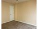 Neutral bedroom features a door and plush carpet at 3220 Warren Creek Dr, Powder Springs, GA 30127