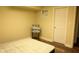 Bedroom with hardwood floors, yellow walls, white trim, bed, and a door at 3220 Warren Creek Dr, Powder Springs, GA 30127