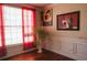 Dining room with bright natural light, red curtains, and hardwood floors at 3220 Warren Creek Dr, Powder Springs, GA 30127
