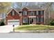 Charming two-story red brick home with well-maintained lawn and two-car garage at 3220 Warren Creek Dr, Powder Springs, GA 30127