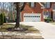 Attached two-car garage featuring driveway and partial view of front lawn at 3220 Warren Creek Dr, Powder Springs, GA 30127