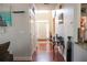 Hallway view featuring hardwood flooring and access to the front door at 3220 Warren Creek Dr, Powder Springs, GA 30127