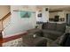Living room with stairs, a sectional sofa, soft rug and a view to the kitchen with stainless appliances at 3220 Warren Creek Dr, Powder Springs, GA 30127