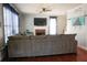 Spacious living room with a large sectional sofa, fireplace, and windows with blue curtains at 3220 Warren Creek Dr, Powder Springs, GA 30127