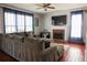Comfortable living room with a large sectional sofa, fireplace, and windows with natural light at 3220 Warren Creek Dr, Powder Springs, GA 30127