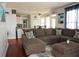 Cozy living room featuring a sectional sofa, soft rug, and an open view to the kitchen and breakfast nook at 3220 Warren Creek Dr, Powder Springs, GA 30127