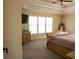 Bedroom boasts a trey ceiling and large window, with a TV on the dresser at 3220 Warren Creek Dr, Powder Springs, GA 30127