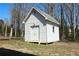 This is a white outbuilding with double doors and a window, perfect for extra storage at 3220 Warren Creek Dr, Powder Springs, GA 30127