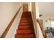 Staircase with wood stairs and railing at 3220 Warren Creek Dr, Powder Springs, GA 30127