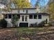 Backyard view of white two story house with screened in porch at 695 Pine Shadows Dr, Dallas, GA 30157