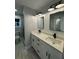 Modern bathroom featuring double vanity, black fixtures, and shiplap walls at 695 Pine Shadows Dr, Dallas, GA 30157