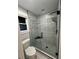 Bright bathroom with pebble-floored shower and sleek glass enclosure at 695 Pine Shadows Dr, Dallas, GA 30157