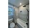 Cozy bathroom features shower/tub combo with window and modern fixtures at 695 Pine Shadows Dr, Dallas, GA 30157