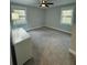 Inviting bedroom with a ceiling fan, carpet, and two windows at 695 Pine Shadows Dr, Dallas, GA 30157