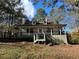 Charming home with a cozy front porch, dormer windows, and a well-maintained yard surrounded by lush trees at 695 Pine Shadows Dr, Dallas, GA 30157