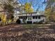 Charming two-story home with a screened-in porch and well-maintained landscaping surrounded by trees at 695 Pine Shadows Dr, Dallas, GA 30157
