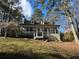 Charming home with a cozy front porch, dormer windows, and a well-maintained yard surrounded by lush trees at 695 Pine Shadows Dr, Dallas, GA 30157