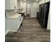 Bright kitchen featuring white cabinets, hardwood flooring, and modern fixtures and stainless steel appliances at 695 Pine Shadows Dr, Dallas, GA 30157